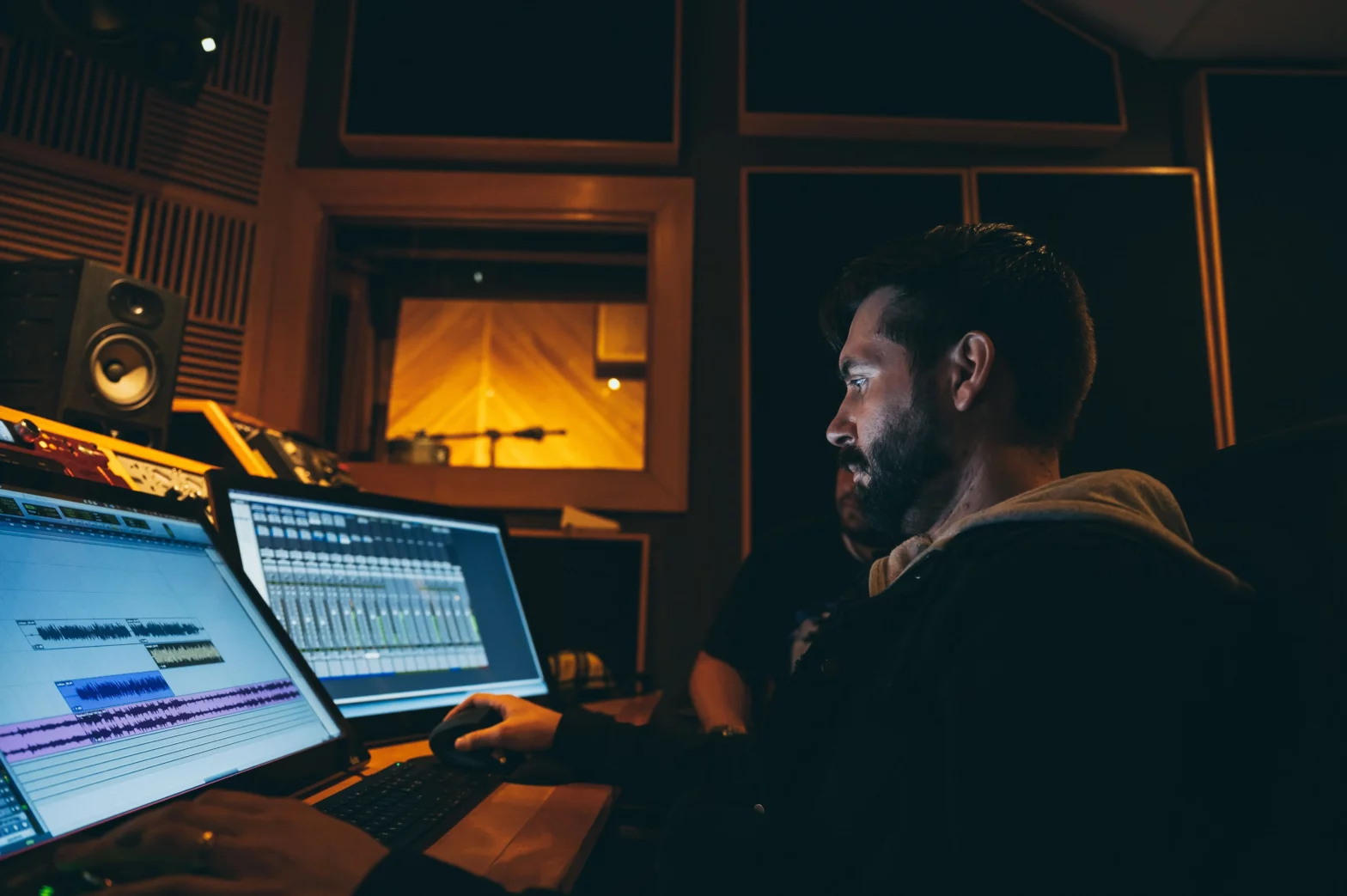 Man sitting at a desk with a music software open - editing reverb