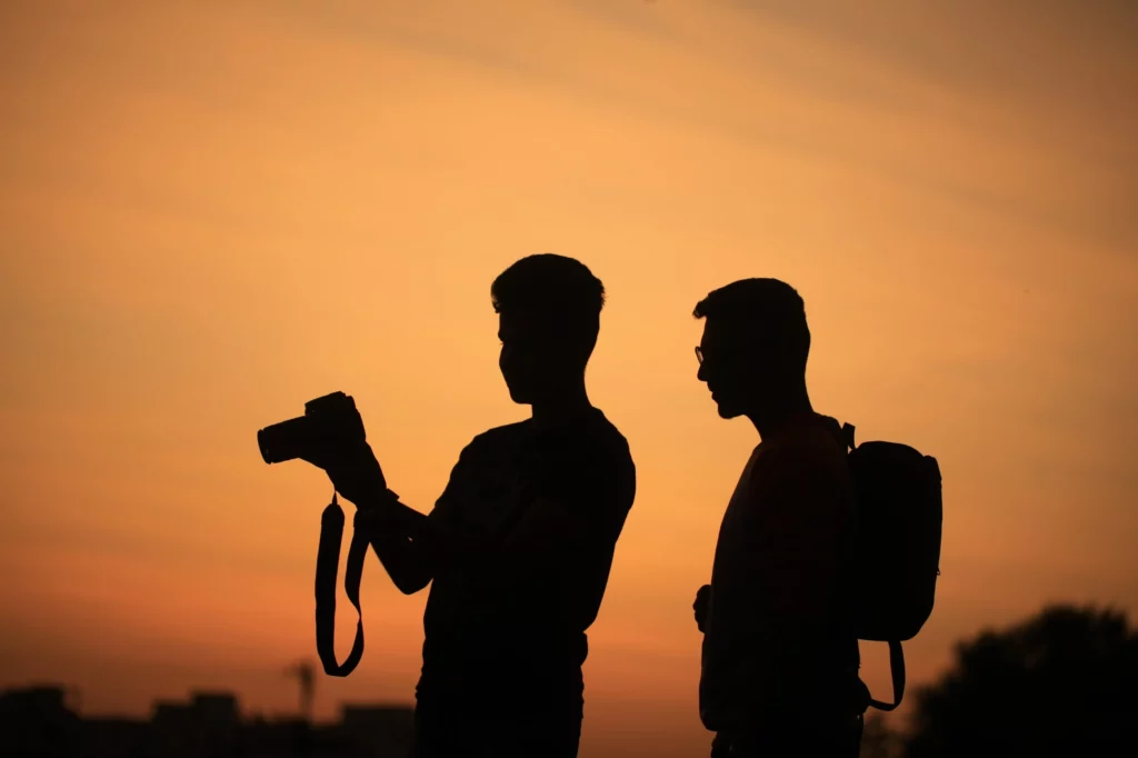 two people with cameras